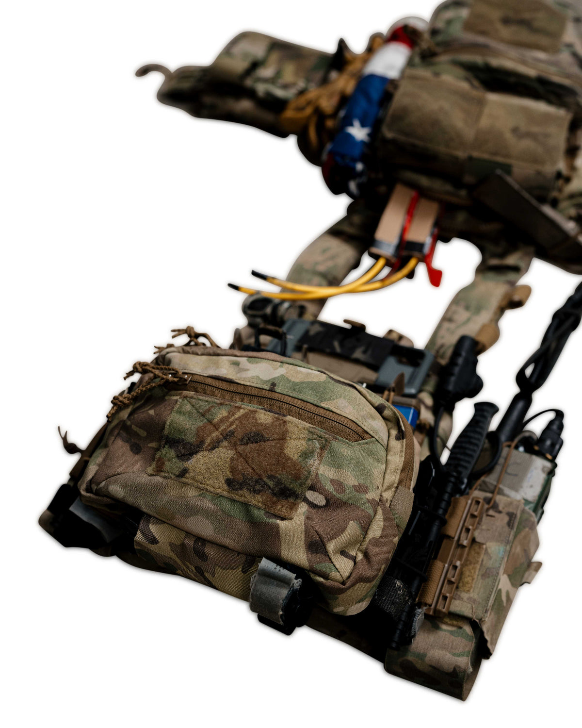 A tactical vest and hip pouch system in camouflage fabric, shown against a plain white background. The gear includes multiple pouches, straps, and attached accessories.