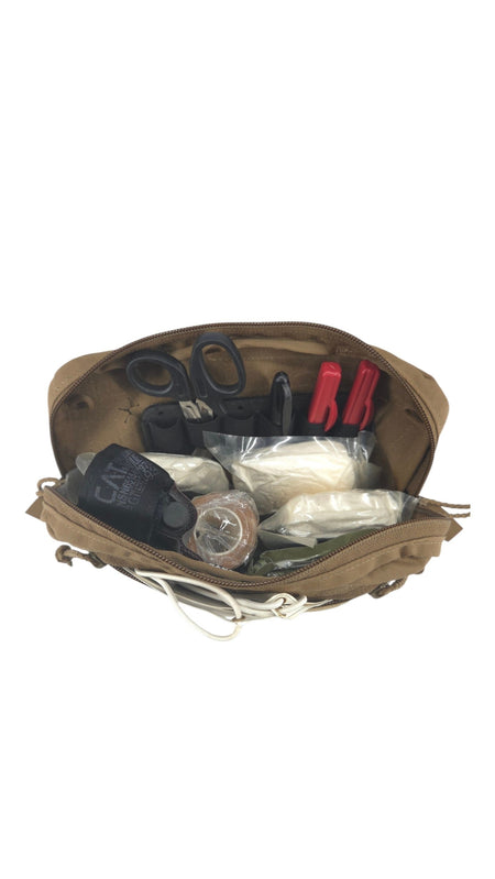 An open tan utility pouch or first-aid/field kit bag showing its contents, including black gloves, a small clear plastic container, white wrapped items, and red-handled tools, isolated on a white background.