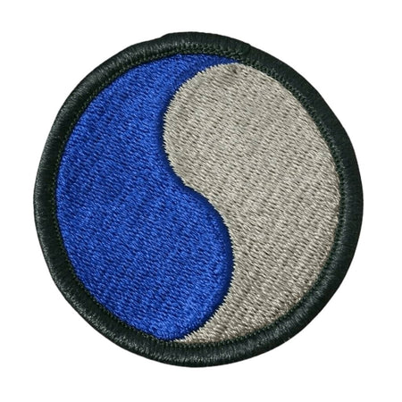 29th Infantry Division Military Color Patch circular featuring a yin-yang symbol in blue and gray, finished with a black stitched border, shown on a plain white background.