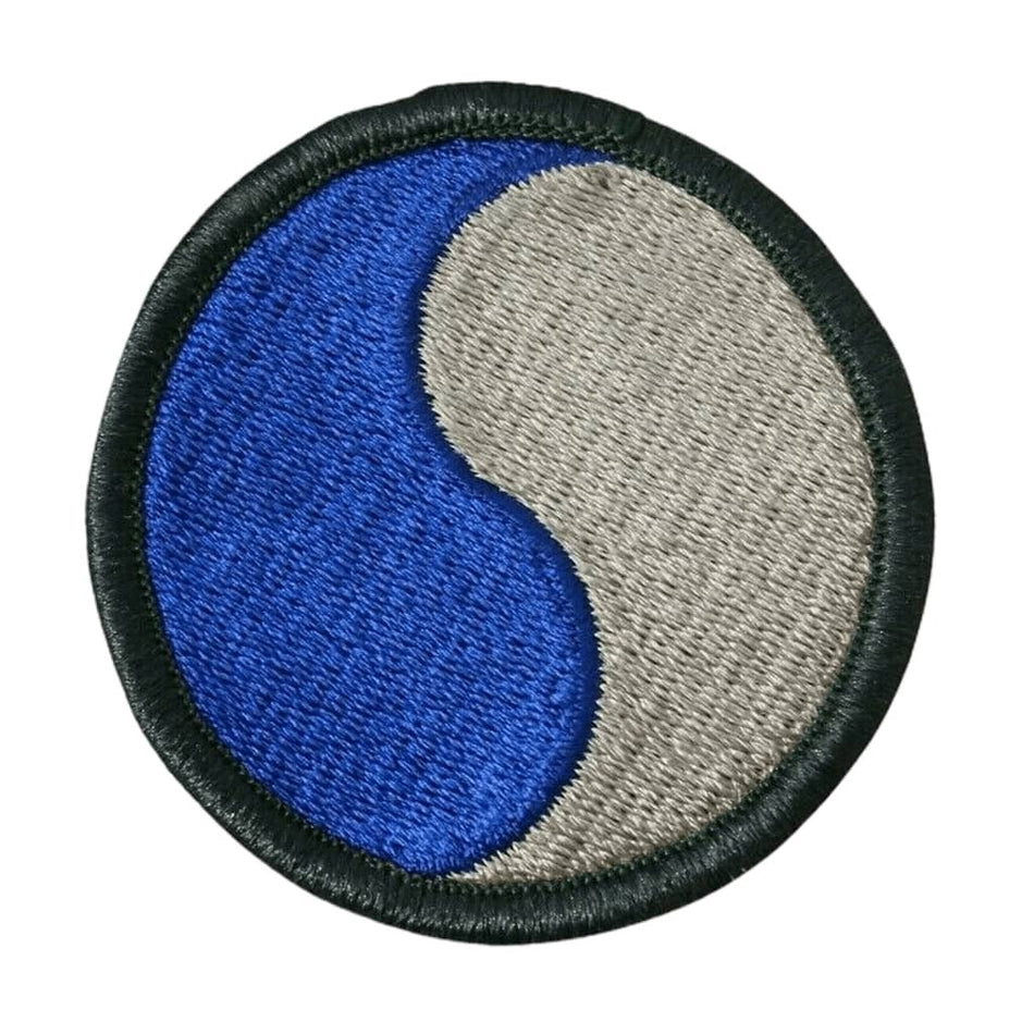 29th Infantry Division Military Color Patch circular featuring a yin-yang symbol in blue and gray, finished with a black stitched border, shown on a plain white background.