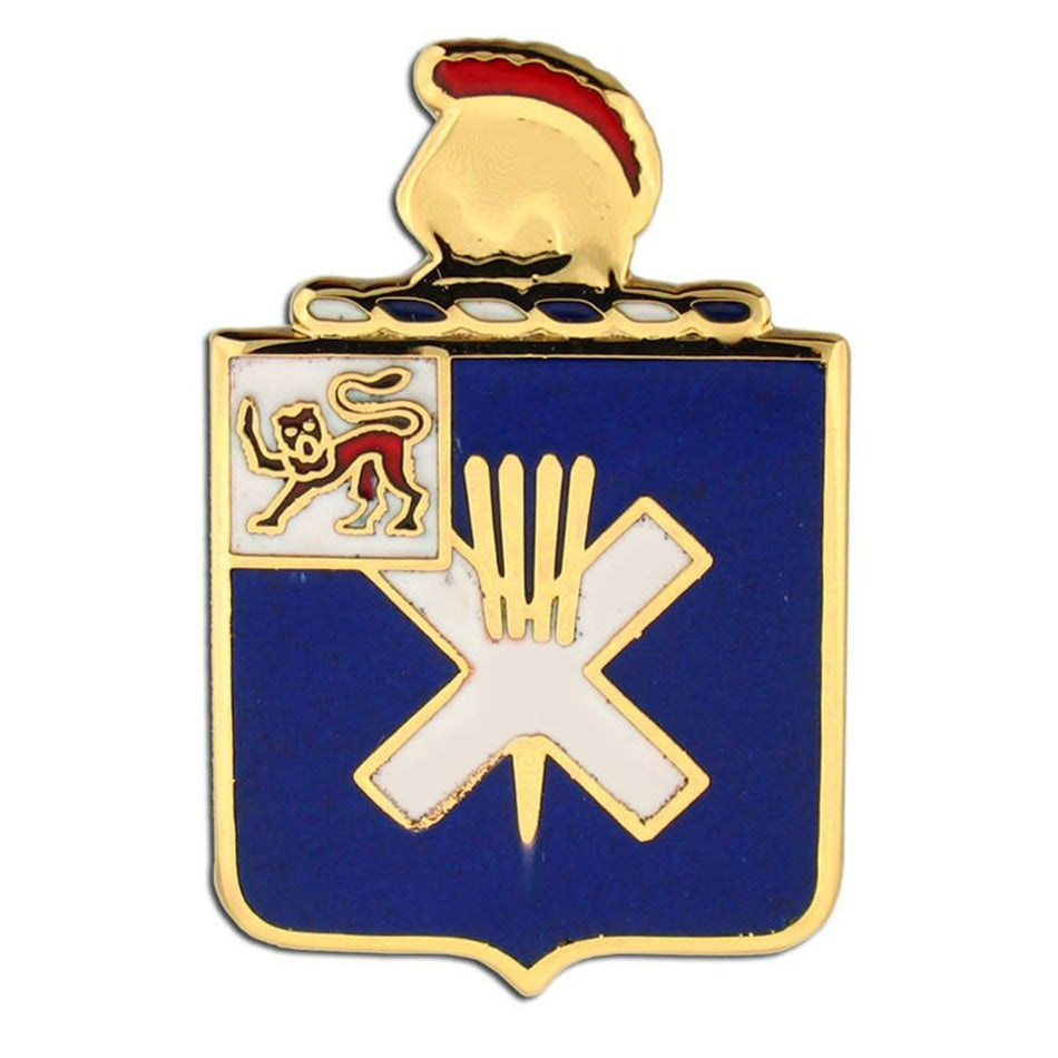 A military-style enamel pin shaped like a shield with a gold-toned border and crest. The main field is dark blue, with a large white X, a small white square containing a red and gold lion emblem, and a gold helmet at the top with a red band.