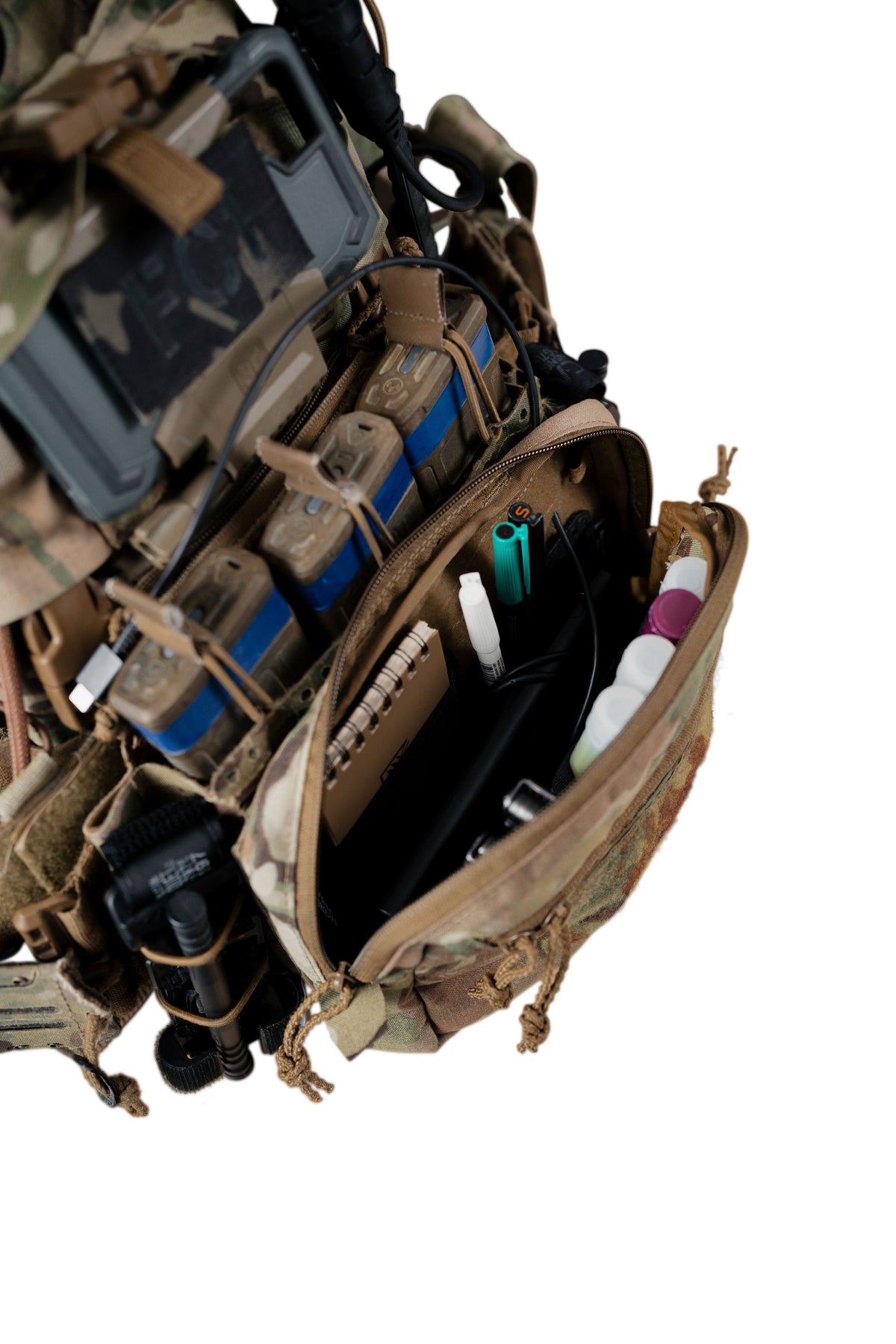 Close-up of a tactical medical pouch on a camouflage combat vest, filled with medical supplies, against a solid white background.