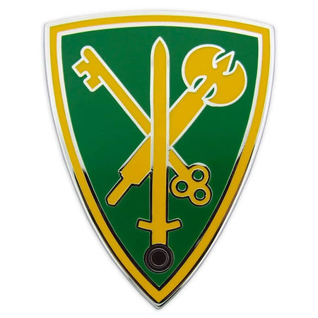 A shield-shaped emblem featuring a green background with yellow border and crossed yellow symbols including a sword, key, and torch, shown on a plain white background.
