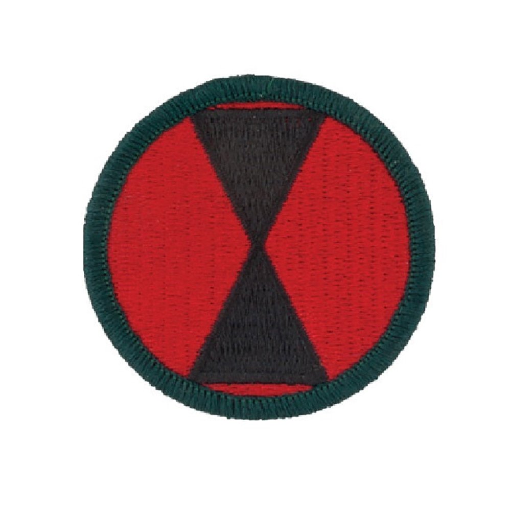 A circular embroidered patch featuring a red background with a black inverted V-shape in the center and a dark green stitched border.