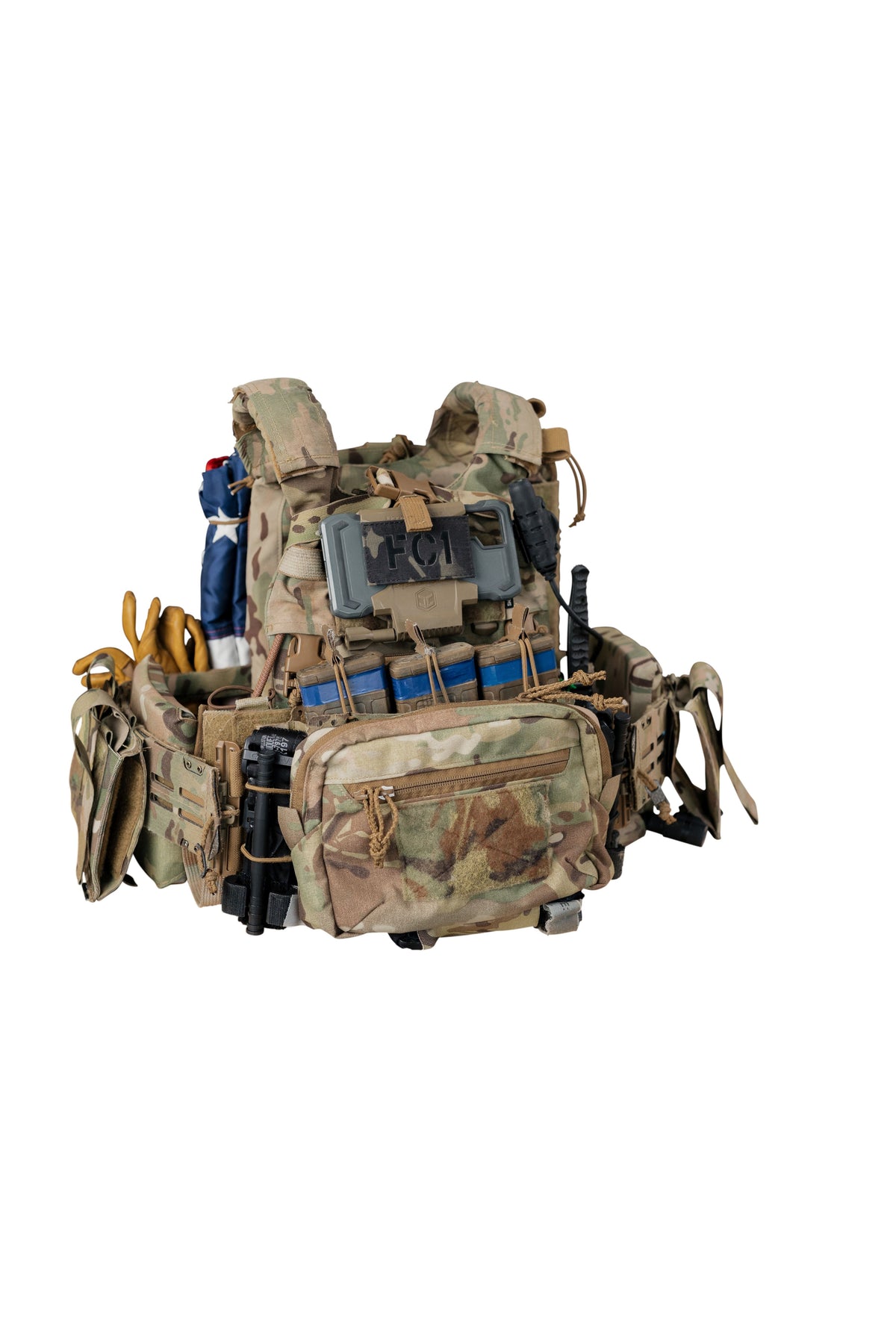 A tactical plate carrier vest in a camouflage pattern, shown against a plain white background. The vest is equipped with multiple external pouches, MOLLE webbing, and various gear attachments.