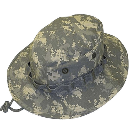 A digital camouflage boonie hat in gray, beige, and green tones, featuring a wide brim, ventilation eyelets, and a chin strap with a plastic toggle, shown against a plain white background.