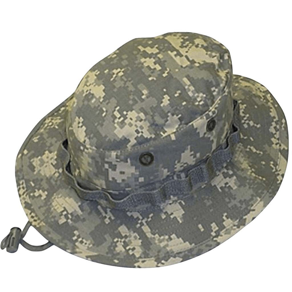 A digital camouflage boonie hat in gray, beige, and green tones, featuring a wide brim, ventilation eyelets, and a chin strap with a plastic toggle, shown against a plain white background.
