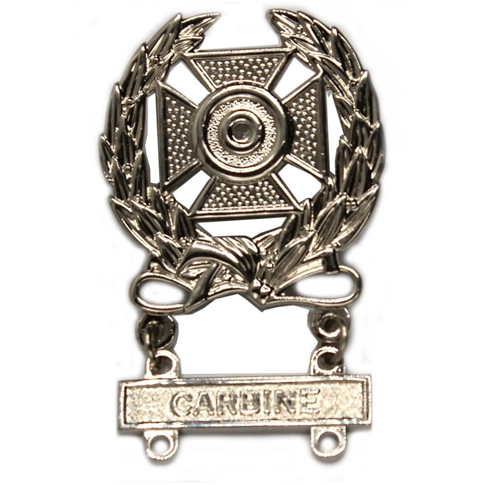 A silver-toned metal badge featuring a Maltese cross with a laurel wreath and a hanging bar engraved with the word 'CARDBINE'.