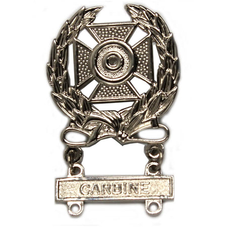 A silver-toned metal badge featuring a Maltese cross with a laurel wreath and a hanging bar engraved with the word 'CARDBINE'.