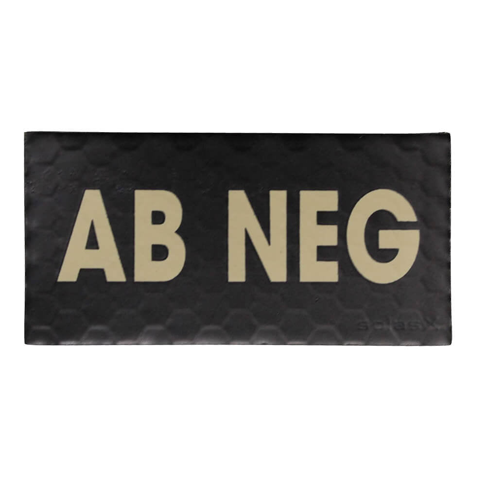 A rectangular black textured mat with the words 'AB NEG' printed in large beige letters, shown on a plain white background.