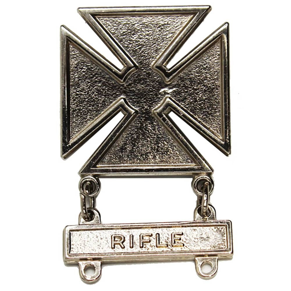 A silver-toned metal military-style insignia featuring a large four-pointed cross above a horizontal bar engraved with the word 'RIFLE'.
