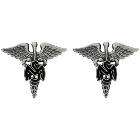 A pair of silver-toned military-style lapel pins featuring a caduceus winged emblem with a black swastika symbol in the center, set against a plain white background.