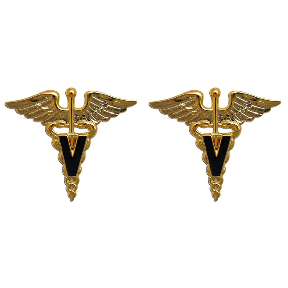 A pair of gold-toned medical insignia pins featuring a caduceus design with a black letter 'V' in the center, set against a plain white background.