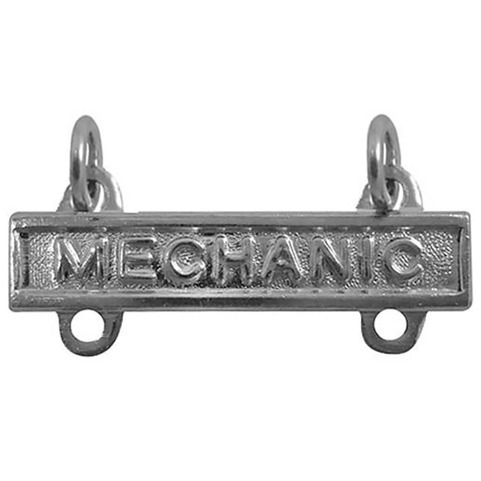 A silver-toned metal bar pendant with the word 'MECHANIC' embossed across the front, featuring two hanging loops at the top and two circular holes at the bottom, shown on a plain white background.