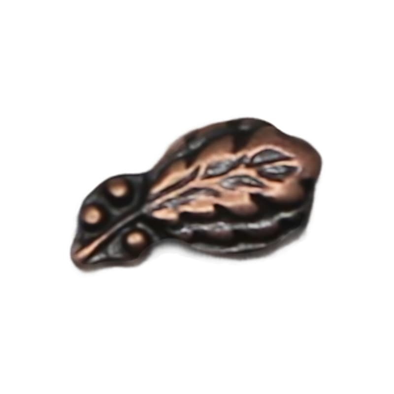 Decorative copper leaf-shaped object on a white background