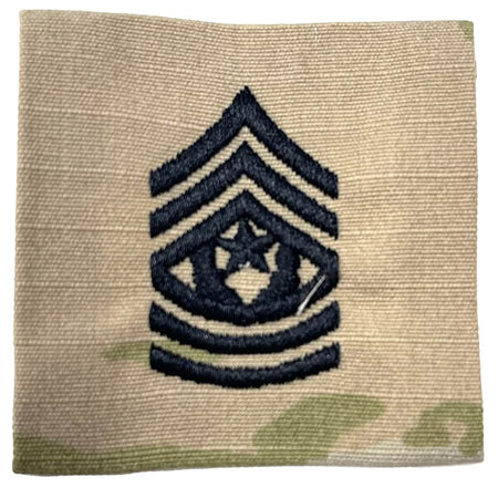 An embroidered Army Command Sergeant Major CSM Rank Patch on a beige camouflage fabric background, featuring a dark navy chevron with a star and crescent emblem.