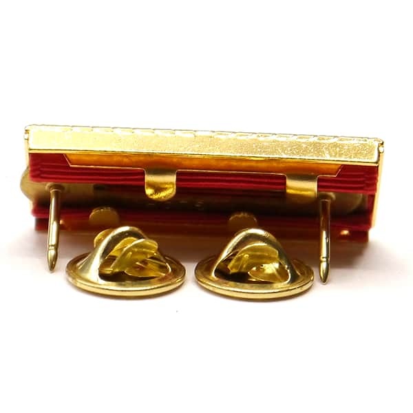 Gold-colored metal clip with two hooks on a white background