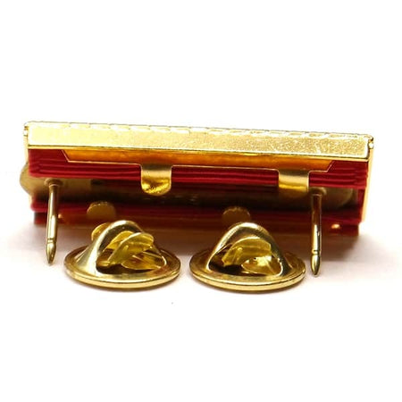 Gold-colored metal clip with two hooks on a white background