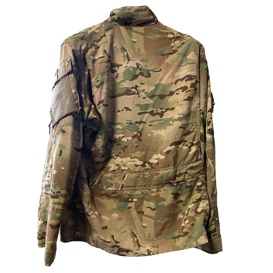 A Multicam OCP Aircrew Coatfrom the back, featuring a multi-terrain pattern in shades of green, brown, and tan, with a high collar and a vertical seam detail on the left shoulder.