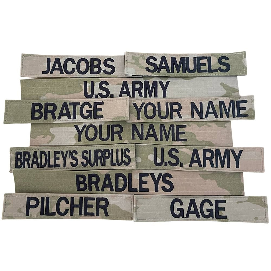 Stack of U.S. Army name tags with various names printed on them.