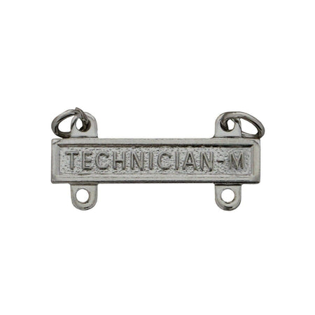 A rectangular silver-toned metal badge or emblem with the embossed text 'TECHNICIAN-M' and two small hanging loops at the top, shown on a plain white background.