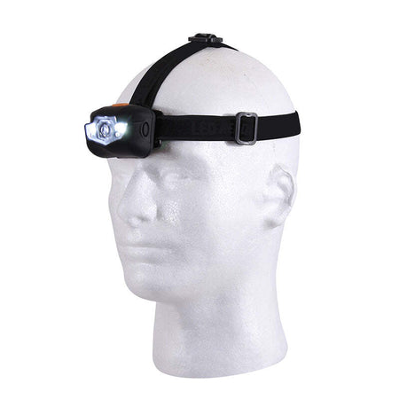 A black tactical headlamp with a bright white LED light turned on, mounted on a black adjustable head strap with a metal buckle, displayed on a white styrofoam mannequin head against a white background.