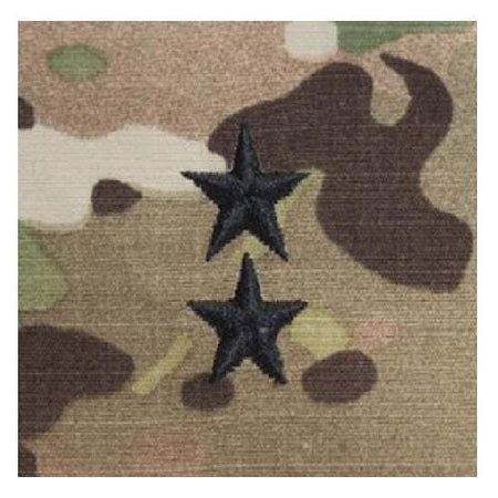 Two black embroidered five-pointed stars on a tan and brown camouflage fabric background.