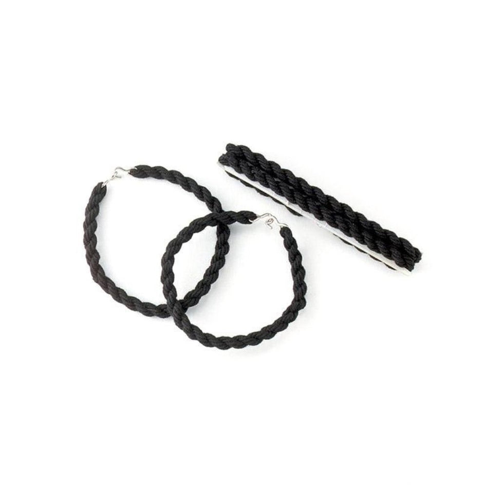 Black braided hoop earrings with silver-tone metal clasps, shown on a plain white background alongside a matching black braided hair tie or hair extension piece.