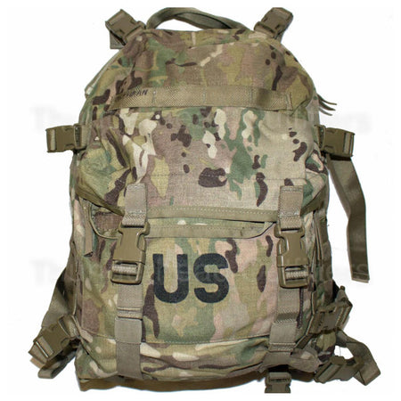 A tactical backpack in a Multicam camouflage pattern, featuring a front pocket with a black 'US' print and multiple adjustable straps and buckles, shown against a plain white background.
