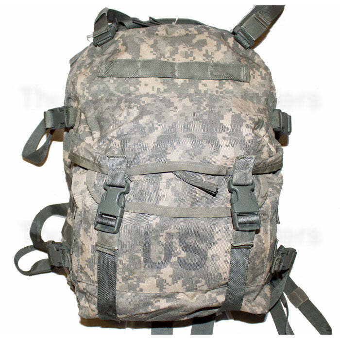 A military tactical backpack in digital camouflage pattern, featuring multiple compression straps with quick-release buckles and a large 'US' printed on the front pocket.