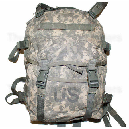 A military tactical backpack in digital camouflage pattern, featuring multiple compression straps with quick-release buckles and a large 'US' printed on the front pocket.