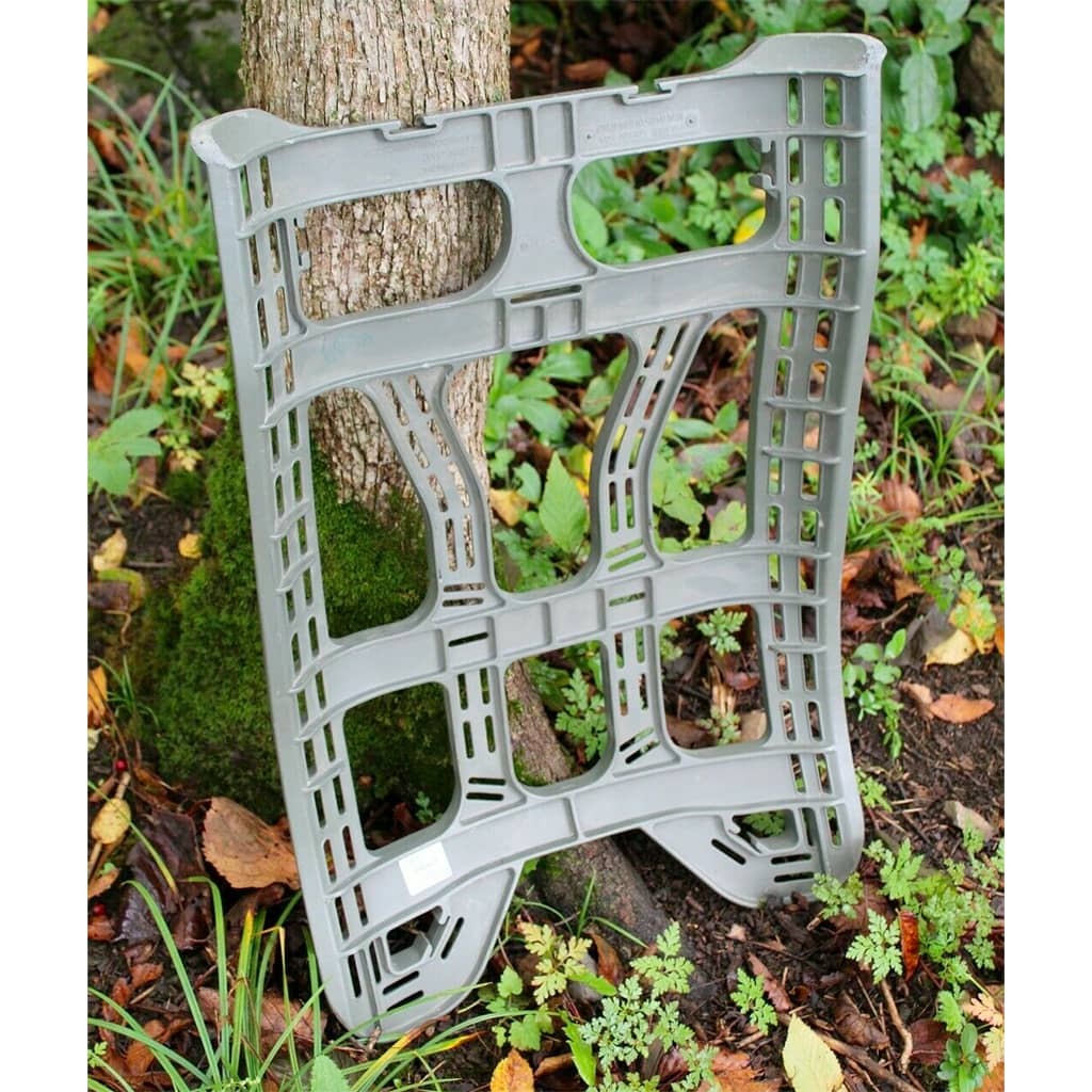 Plastic Molded Frame for Large Rucksack, shown leaning against a tree bark in an outdoor setting with moss, leaves, and grass.