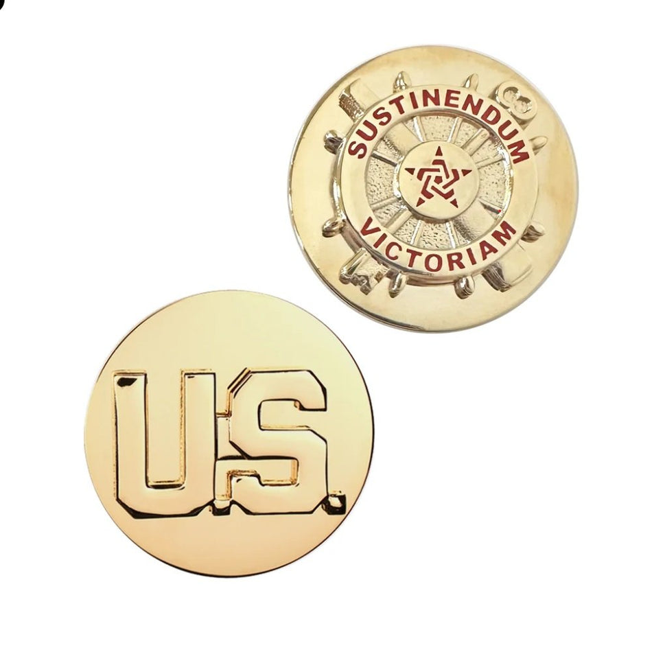 Two round gold-toned metal pins or badges on a plain white background. The lower pin shows large raised letters 'US', and the upper pin shows a ship wheel design with the words 'SUSTINENDUM' and 'VICTORIAM' in red around a central emblem.