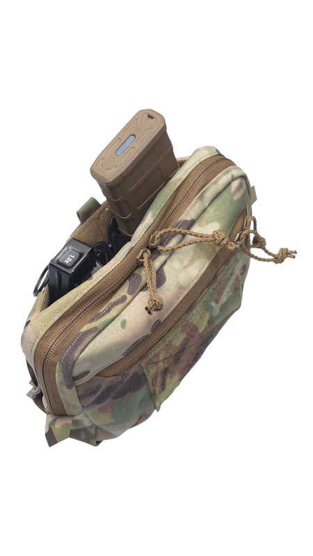 A tactical utility pouch in a Multicam camouflage pattern, shown with a tan magazine inserted into its top compartment against a plain white background.