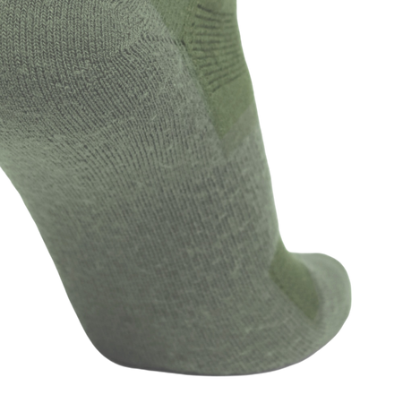 A close-up of a single knit sock in a muted sage green color, showing the textured fabric and toe area against a plain white background.