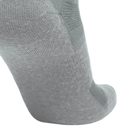 A close-up of a light gray knit sock showing the textured fabric and toe area against a plain white background.