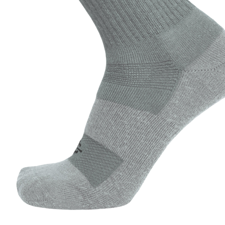An olive green athletic sock shown on a foot form, highlighting its ribbed knit texture and reinforced zones on the toe and arch, set against a plain white background.