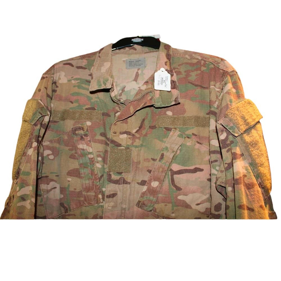 Army FRACU Jacket Flame-Resistant Combat Uniform Coat in a OCP camouflage pattern, featuring a button-up front, chest pockets, and reinforced elbow patches, shown on a hanger against a white background.