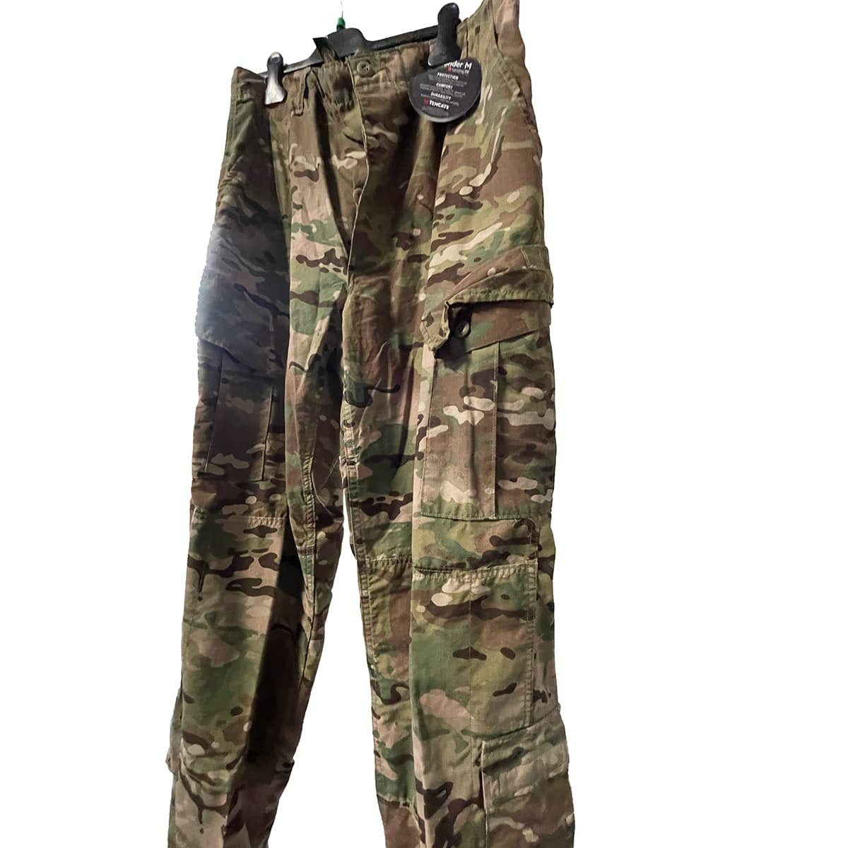 FRACU Multicam Pants with reinforced knee patches and a black hangtag, shown hanging on a black hanger against a white background.