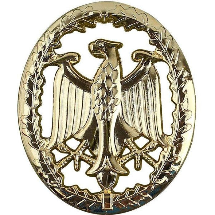 A gold-colored oval emblem featuring a detailed eagle motif with outstretched wings, set against a laurel wreath background, isolated on a white backdrop.