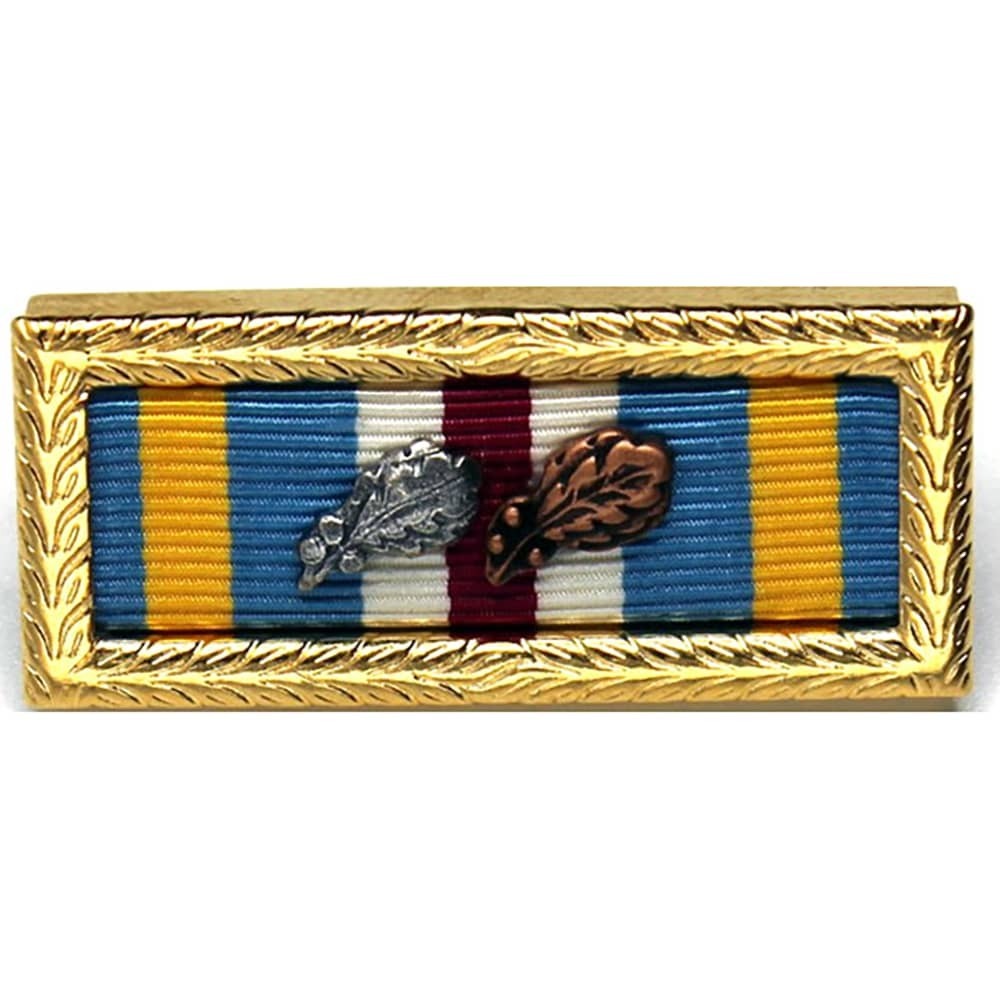 Joint Meritorious Unit Award Citation with Awards Assembled with a decorative gold frame, featuring blue, yellow, white, and burgundy stripes with two small oak leaf emblems in silver and bronze tones.