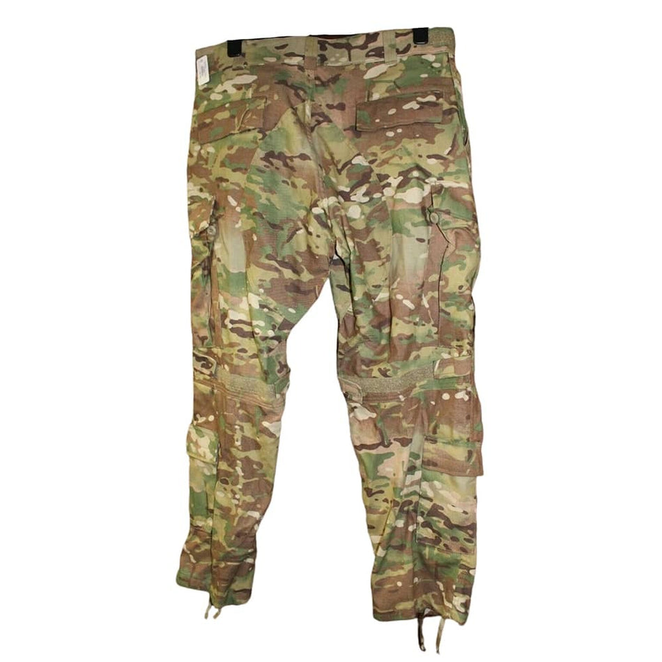 A pair of military cargo pants in a multicam camouflage pattern, featuring a mix of green, brown, tan, and beige tones. The pants are shown flat against a solid white background.