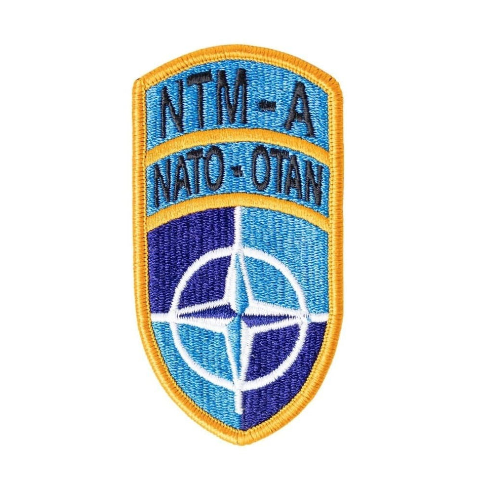 NATO patch with blue and yellow colors on a white background