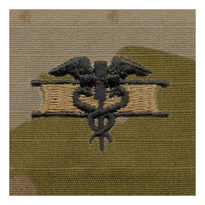 Embroidered medical symbol on a green fabric background