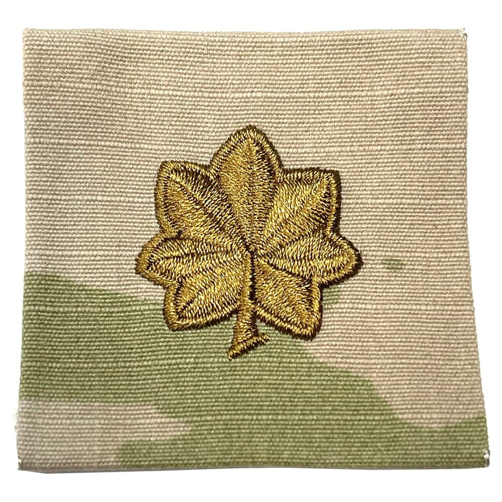 MAJ Major Army Rank Sew-On OCP Patch in gold thread, centered on a square fabric swatch with a beige and olive green camouflage pattern.