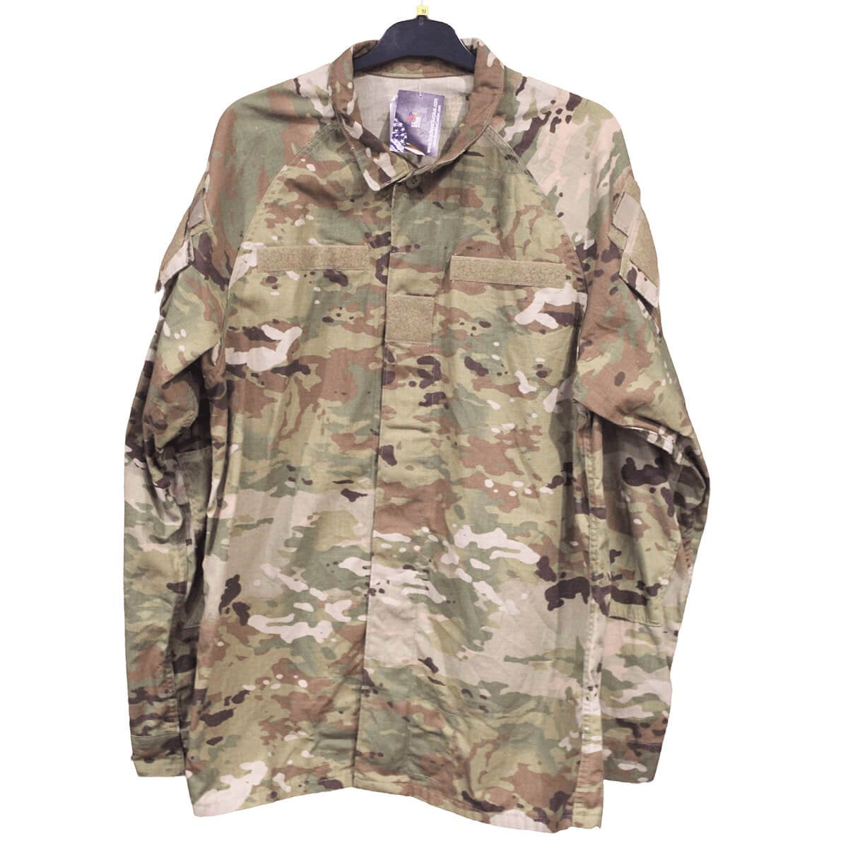 A long-sleeve military-style field jacket in a OCP camouflage pattern, hanging on a black hanger against a plain white background.