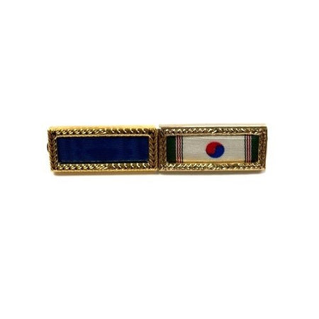 Pin with blue ribbon and flag design on a white background