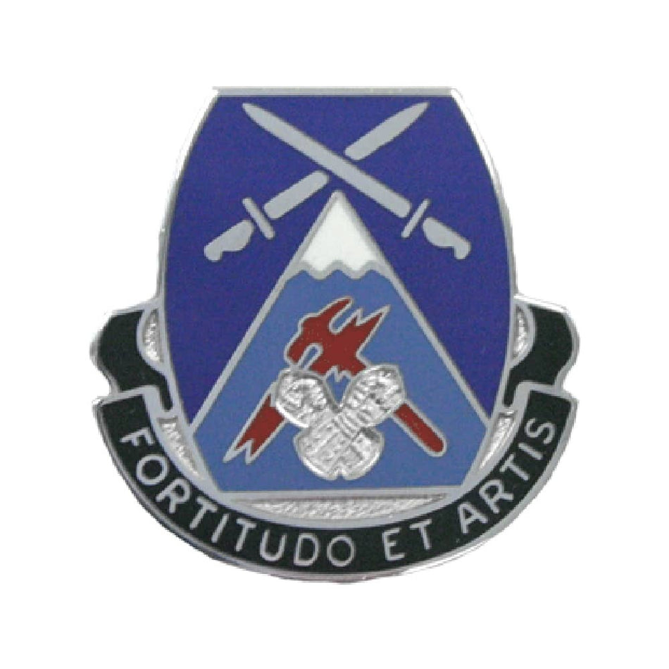 A military unit lapel pin featuring a blue and light blue shield with crossed silver swords, a mountain, and a red and silver emblem, with a black scroll reading 'FORTITUDO ET ARTIS' on a white background.