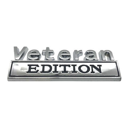 A silver metallic 'Veteran EDITION' emblem badge on a plain white background.