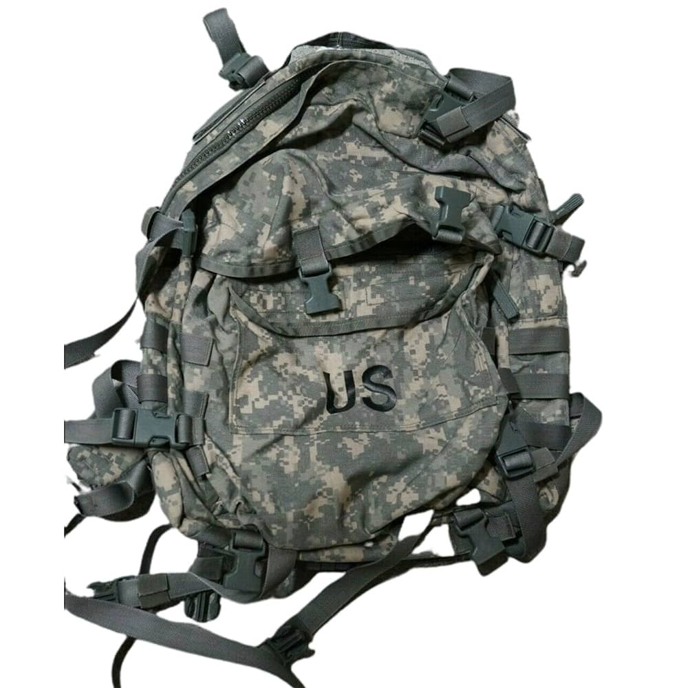 A military tactical backpack in digital camouflage pattern with black straps, buckles, and webbing, featuring the letters 'US' printed on the front pocket.